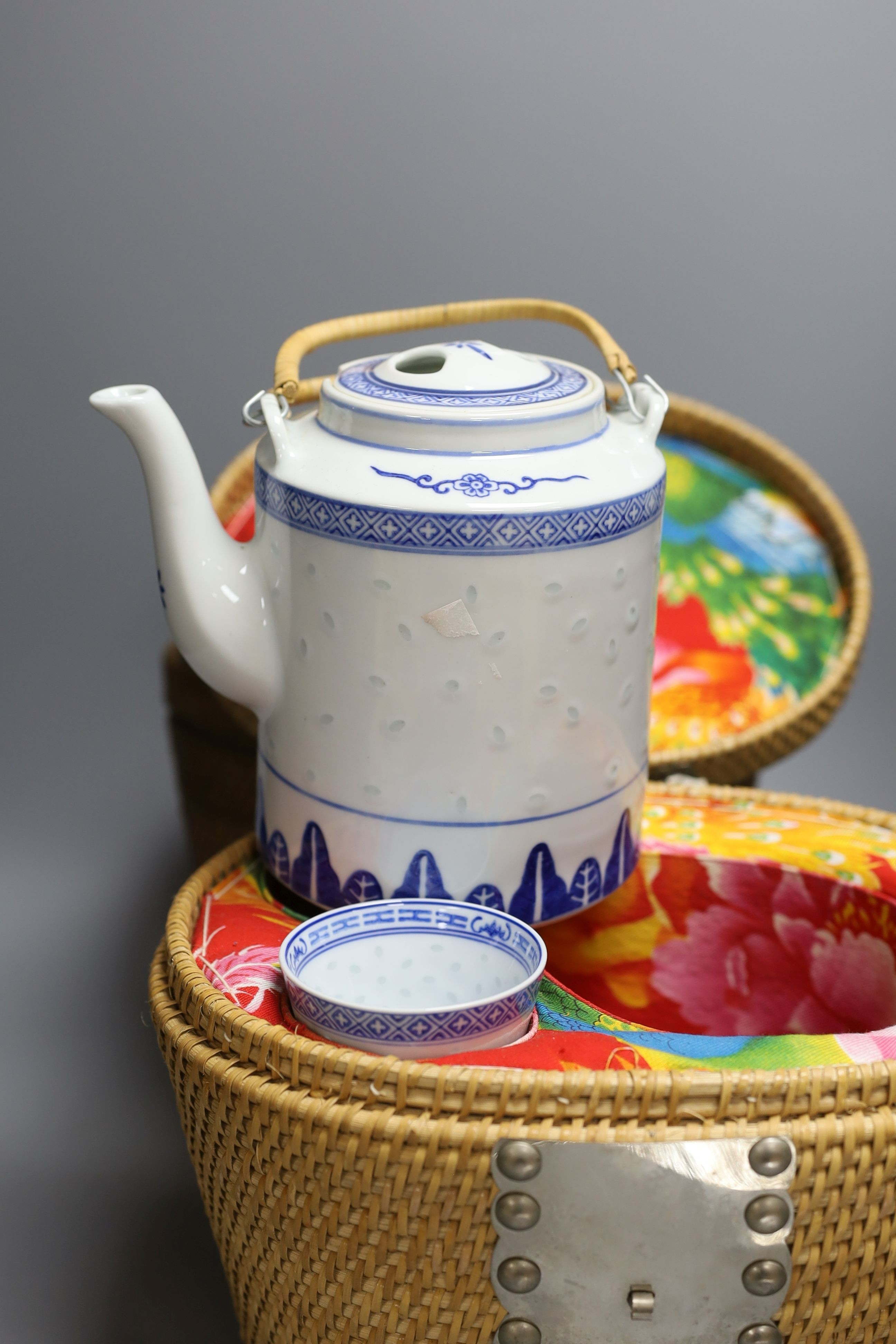 Two wicker-cased Chinese porcelain teapots together with a Chinese celadon dish and yellow vase, 28cm tall, (4)